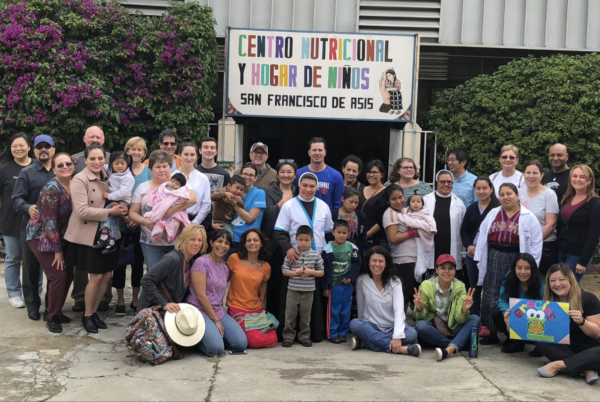 The 2018 team with children and staff at the nutrition center